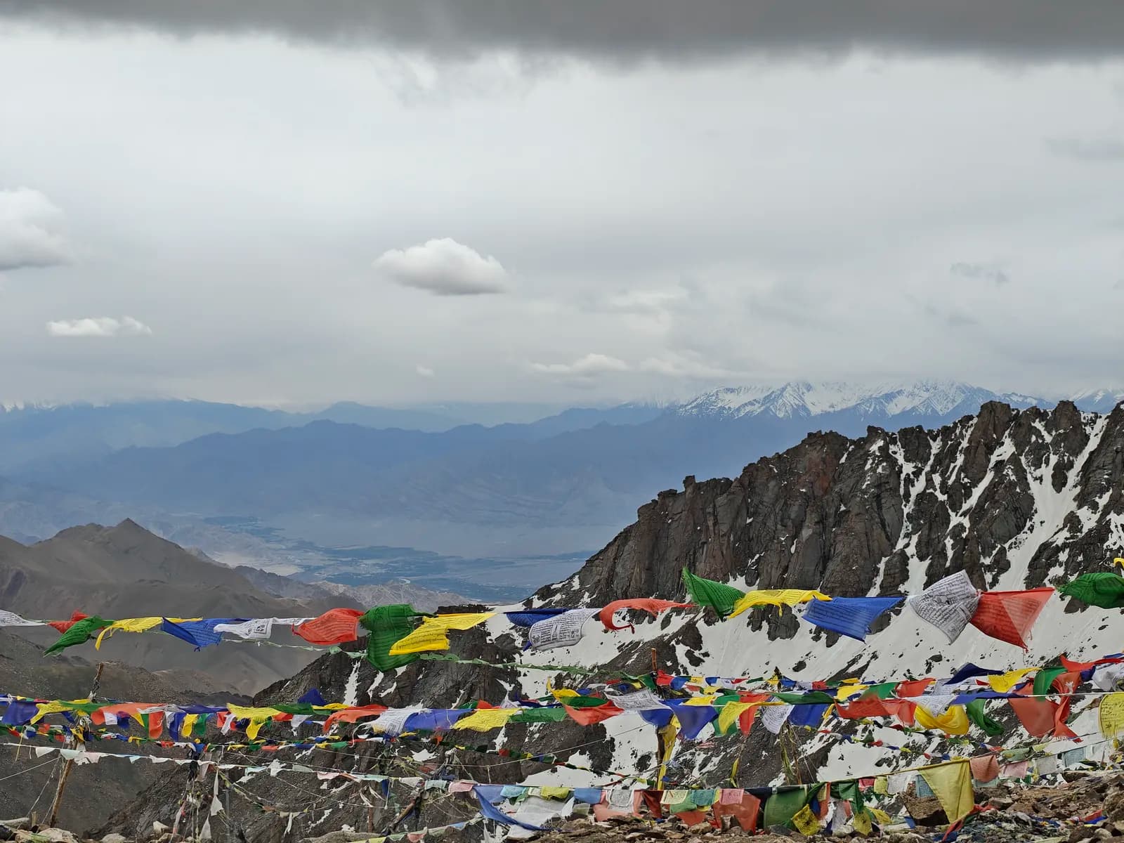 Strings of prayer flags on a snowy pass